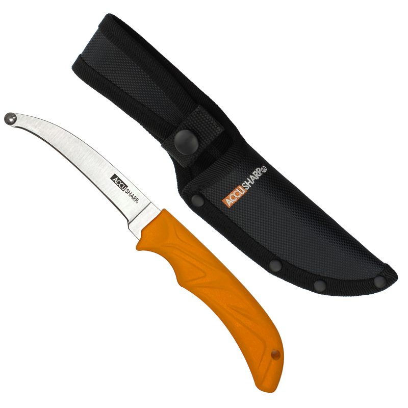 AccuSharp AccuZip Skinning Knife with a bright orange rubber grip, 4-inch stainless steel blade with a blunt tip, and a black nylon sheath with a belt loop, displayed on a rugged outdoor surface.