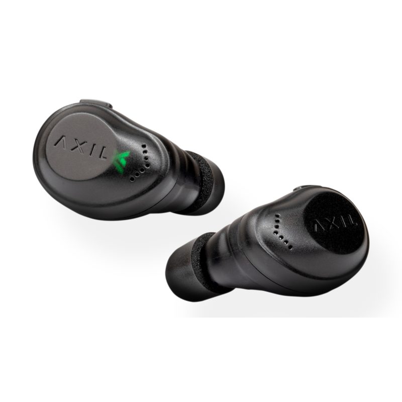 Pair of black AXIL XCOR Bluetooth tactical earbuds with a charging case and USB-C cable, shown on a rugged surface.