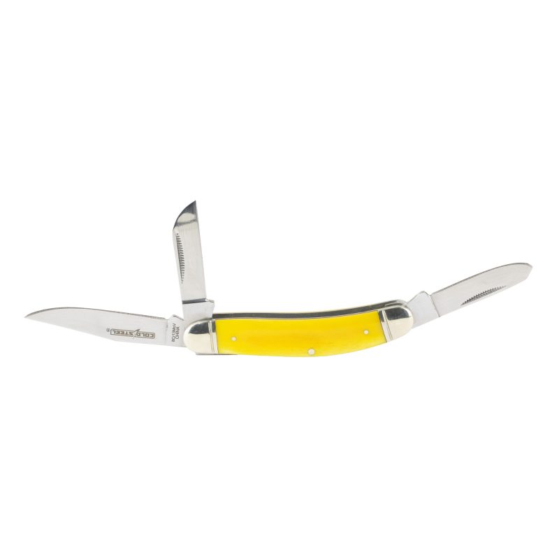 Cold Steel Gentleman's Stockman folding knife with yellow bone handle, featuring three satin-finish blades (clip point, spey, sheepsfoot) open on a rustic surface.