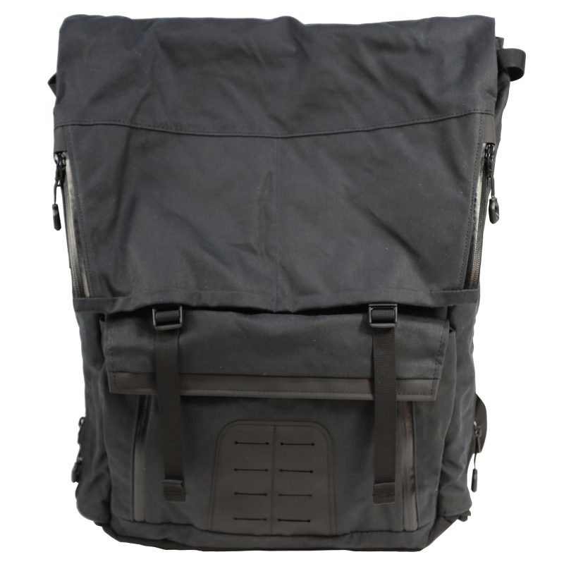 Black waxed canvas Grey Ghost Gear Gypsy Pack 2.0 backpack with flap top and side release buckles, ready for outdoor use.