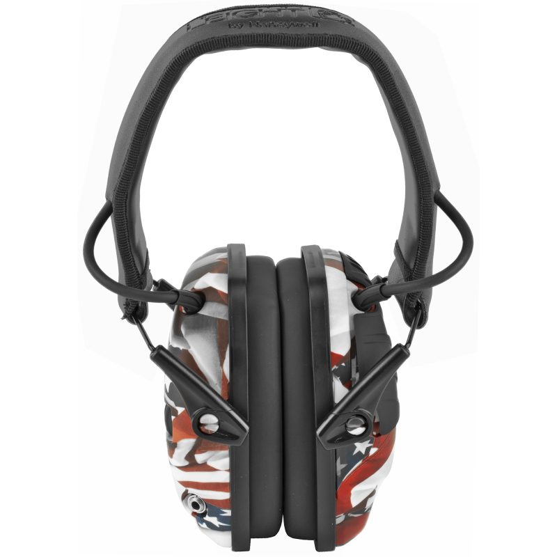 Howard Leight Impact Sport electronic earmuffs with a "One Nation One Flag" finish, folded, on a rugged surface.