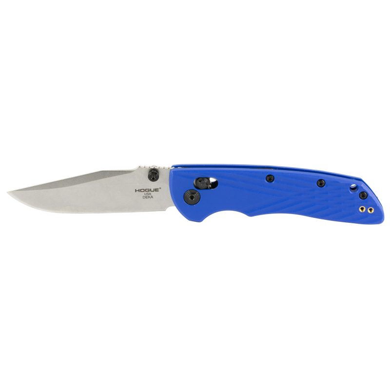 Hogue Deka 3.25 inch folding knife with blue polyamide nylon 12 grips and a silver stone tumble finish CPM MagnaCut plain clip point blade, shown open on a rustic surface.