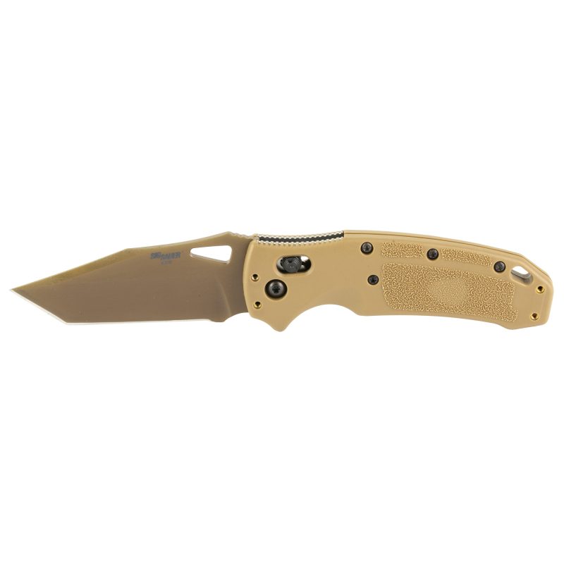 Hogue SIG K320 M17 folding knife with coyote tan PVD finish blade and frame, tanto point, and 3.5-inch plain edge blade, shown open on a rugged surface.