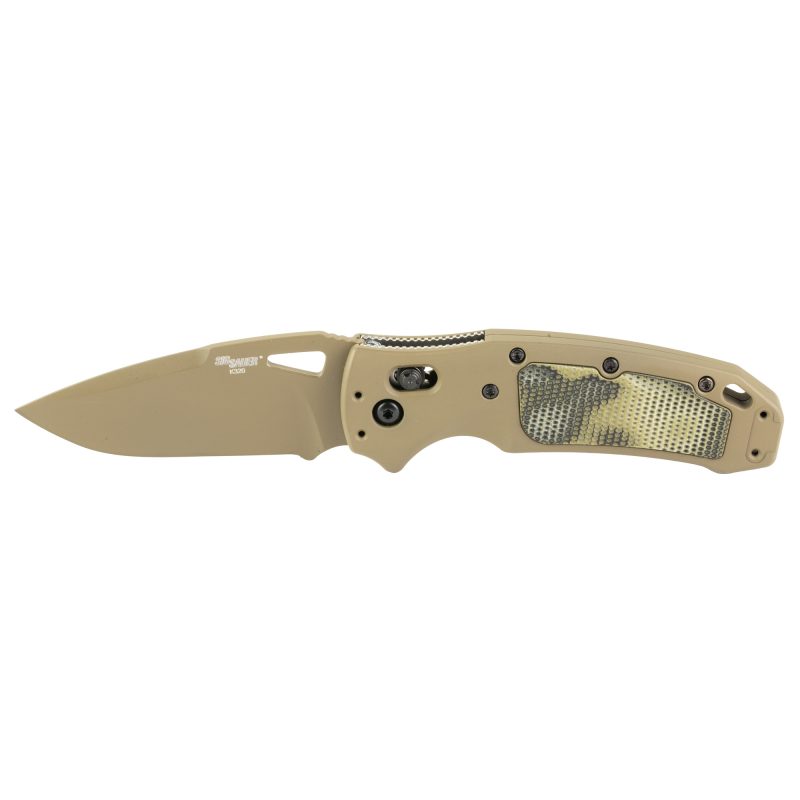 Hogue K320 AXG folding knife with a 3.5-inch FDE Cerakote drop point blade and FDE aluminum grips with green G-Mascus G10 inserts, shown open on a rustic background.