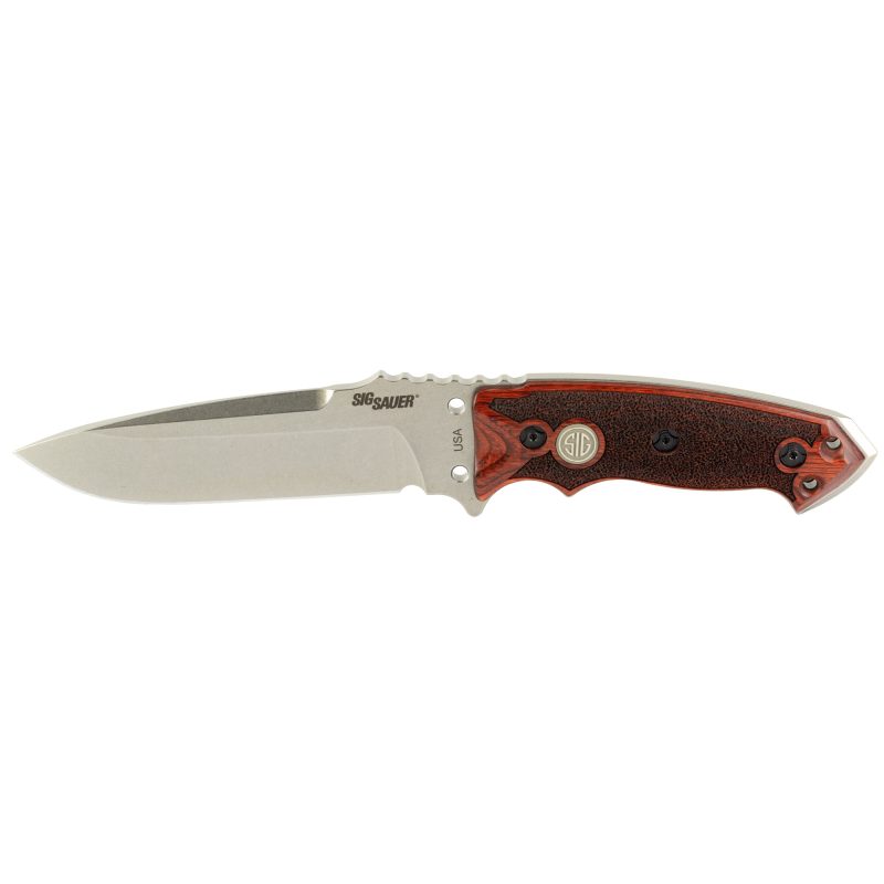 Hogue SIG EX-F01 fixed blade knife with a 5.5-inch drop point A2 tool steel blade, reinforced rosewood handle, and a black ballistic nylon MOLLE sheath, displayed on a rugged outdoor surface.