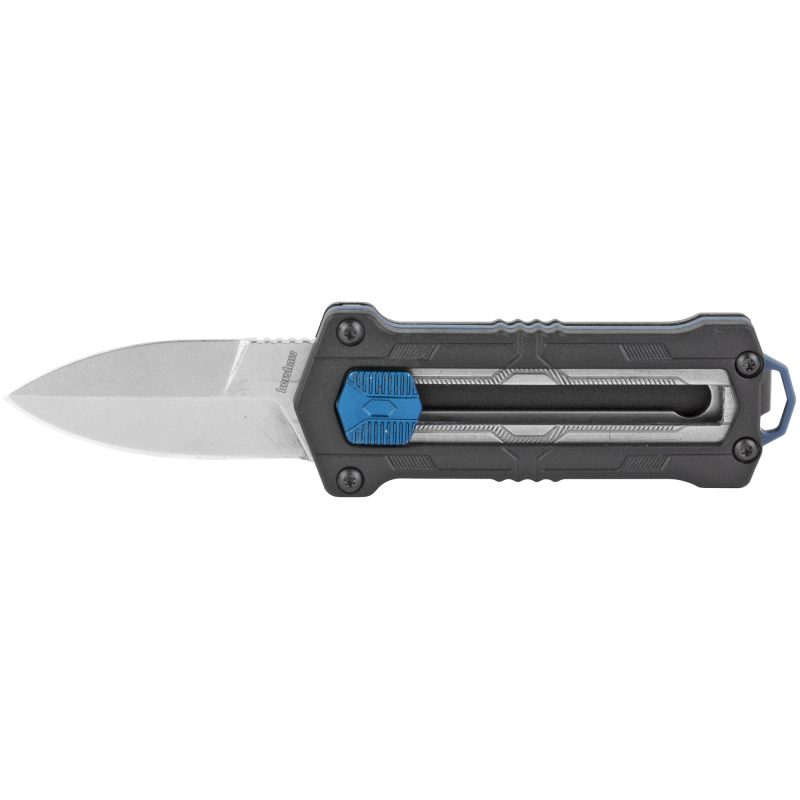 Kershaw Kapsule 1.9 inch black folding knife with a silver spear point blade, shown open on a rugged surface, ready for use on a ranch.