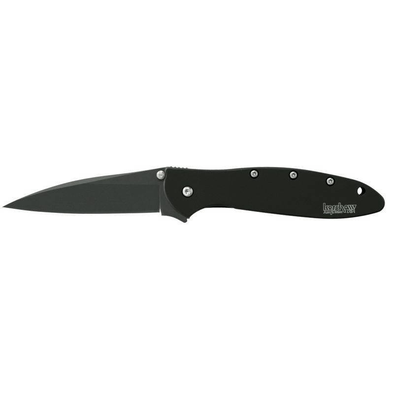 Kershaw Ken Onion Leek Plain Matte Black folding knife with a 3-inch blade, black handle, and pocket clip, shown partially open on a rugged surface.
