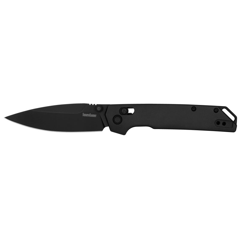 Black Kershaw Iridium 3.4 inch folding knife with a spear point D2 steel blade, PVD coating, and a 6061-T6 aluminum handle, shown open on a rustic surface.