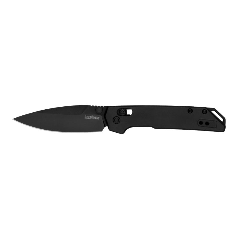 Black Kershaw Mini Iridium folding knife with a 3-inch plain edge spear point D2 steel blade and aluminum handle, shown open on a rustic surface.