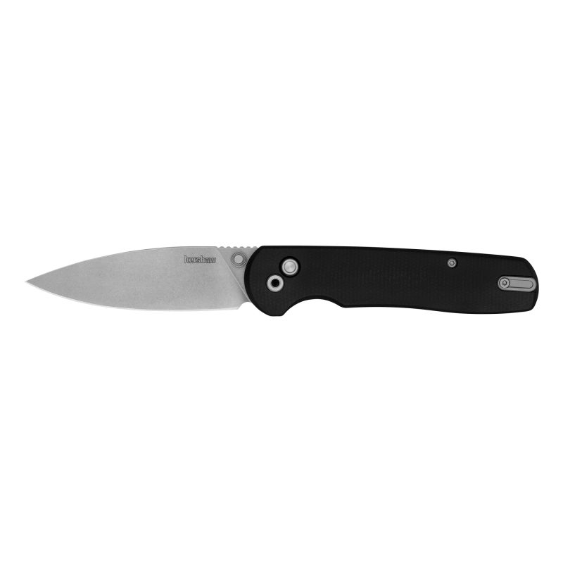 Kershaw Remnant folding knife with a black stonewashed D2 spear point blade and black micarta handle, shown open on a rustic surface.