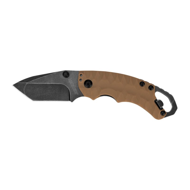 Kershaw Shuffle II folding knife with a tan glass-filled nylon handle and a blackwash finished tanto blade, shown open on a rugged surface.