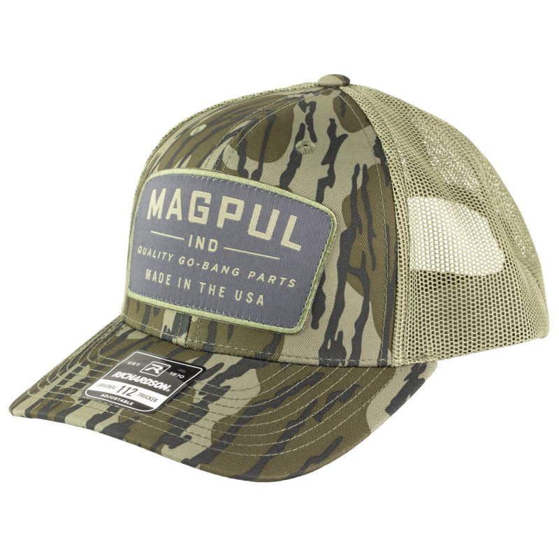 Magpul Industries Go Bang Trucker Hat in Bottomland Camo, featuring a structured front panel with the 'Go Bang' patch, a mesh back, and an adjustable snapback closure.