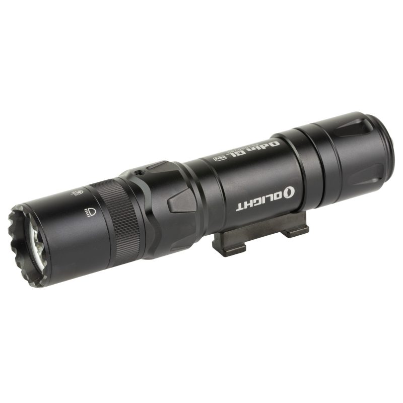 Black Olight Odin Mini GL 1000 lumen weapon light with green laser, mounted on a Picatinny rail, against a dark, rugged background.