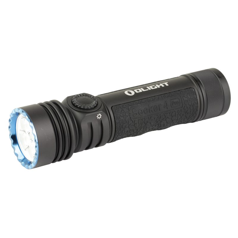 Black Olight Seeker 4 Pro neutral white rechargeable handheld flashlight with 4,600 lumens, shown on a rugged outdoor surface.