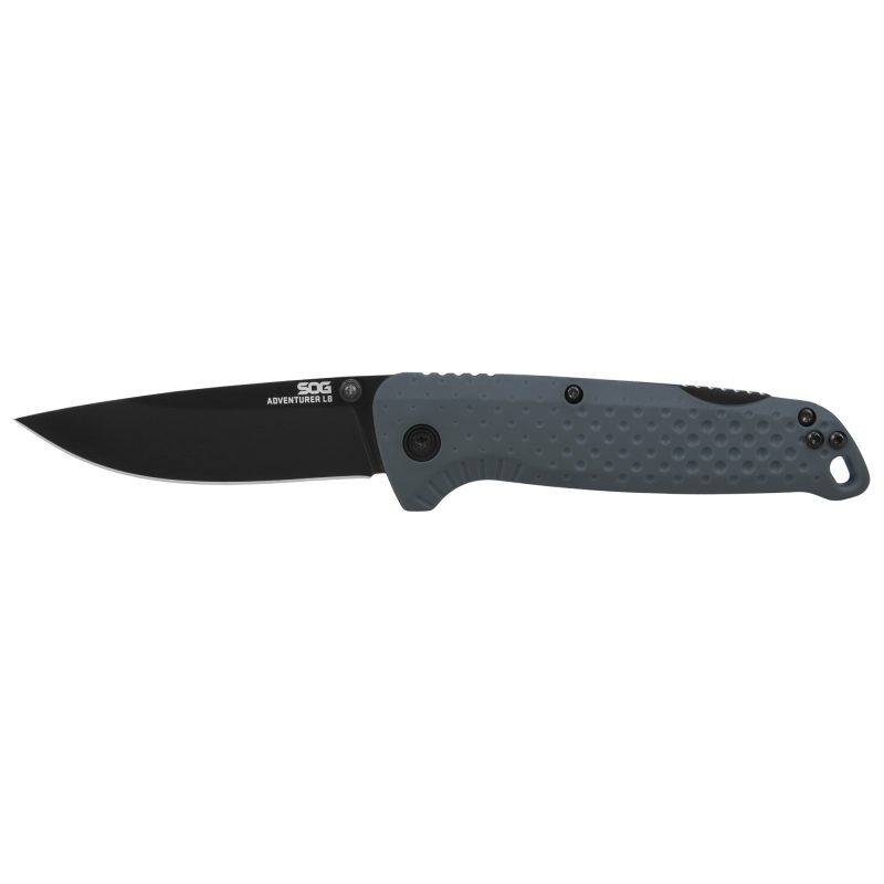 SOG Knives & Tools Adventurer folding knife with a gray and black handle and a 3.5-inch titanium nitride coated clip point blade, shown open on a rustic surface.