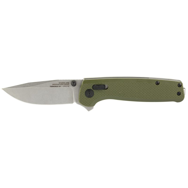 SOG Knives & Tools Terminus XR G10 folding knife with a 2.95 inch stonewashed D2 steel clip point blade and an olive drab green G10 handle, shown open on a rustic surface.