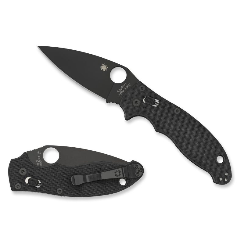 Spyderco Manix 2 folding knife with black blade and black handle, open on a rustic wood surface, ready for ranch work in the White Mountains.