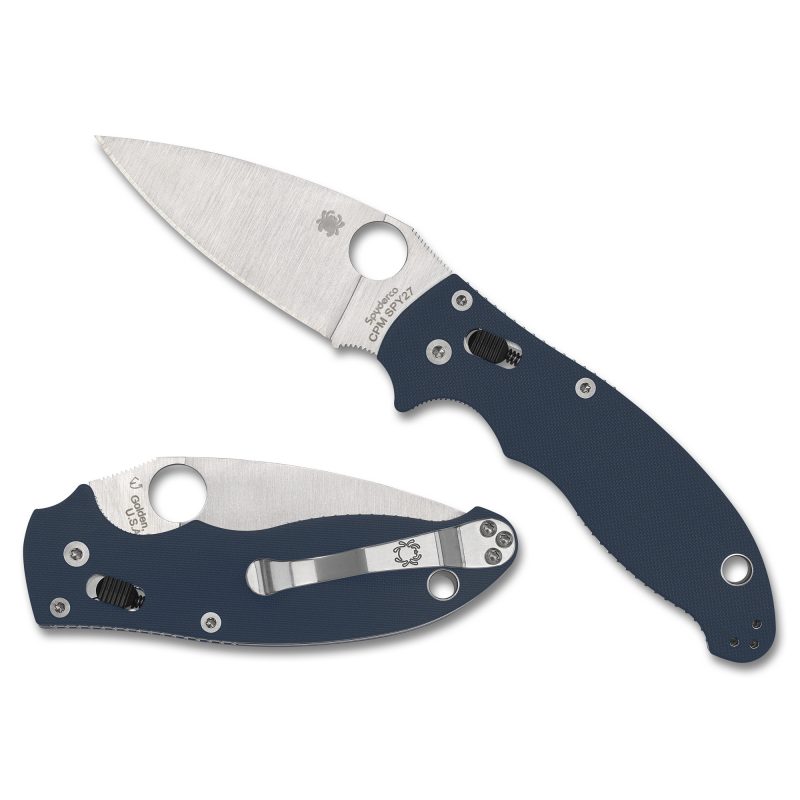 A blue Spyderco Manix2 G-10 folding knife with a silver CPM SPY27 drop point blade, open and ready for use, against a rugged outdoor background.