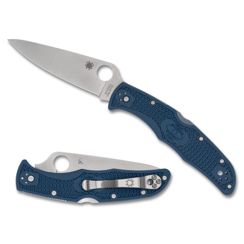 A cobalt blue Spyderco Endura 4 lightweight folding knife with a satin-finished, plain edge drop point blade, shown open on a rustic background.