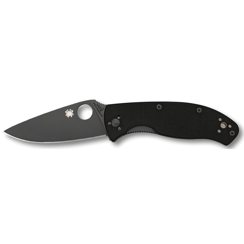 Spyderco Tenacious G-10 Plain Blk folding knife with a black G10 handle and a plain edge VG10 blade, shown open on a rustic surface.