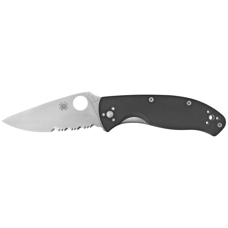 Spyderco Tenacious G-10 Combo Edge folding knife with a black G-10 handle and a satin finish combo blade, shown open on a rustic background.