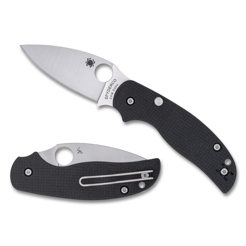 Spyderco Sage 6 folding knife with a satin-finished drop point blade and black carbon fiber/G-10 laminate handle, shown open on a rustic surface.