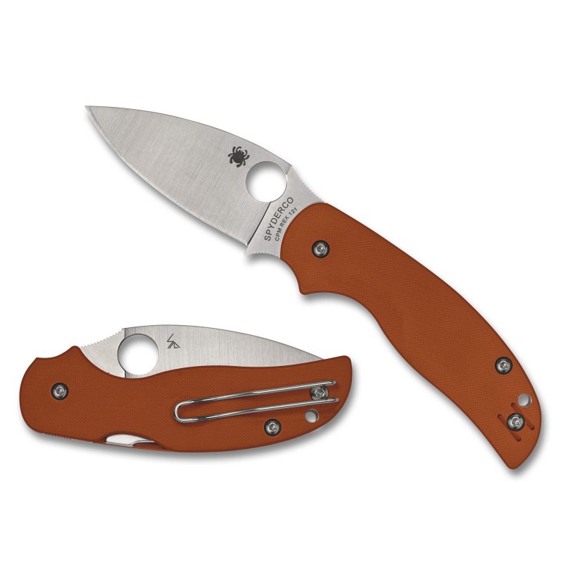 Spyderco Sage 5 folding knife with a silver drop point blade and burnt orange G-10 handle, shown open on a rustic background, ready for ranch work.
