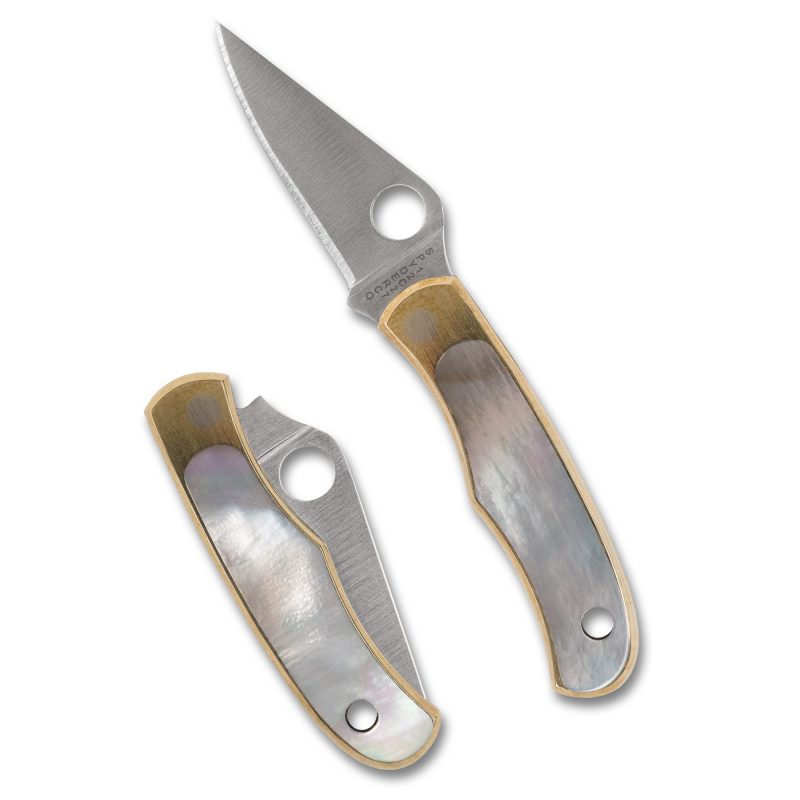 Closed Spyderco Bug 1.25 inch folding knife with silver abalone handle scales and a satin finish blade, shown on a rustic wooden surface.