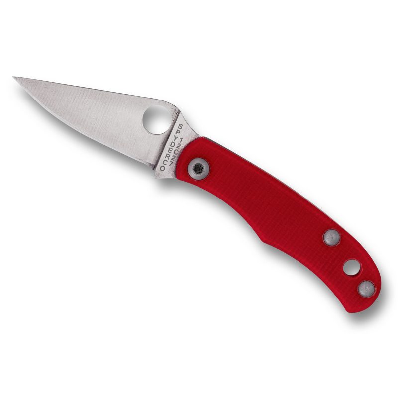 A red Spyderco Bug G-10 folding knife with a silver drop point blade and a textured red G-10 handle, shown open on a rustic surface.
