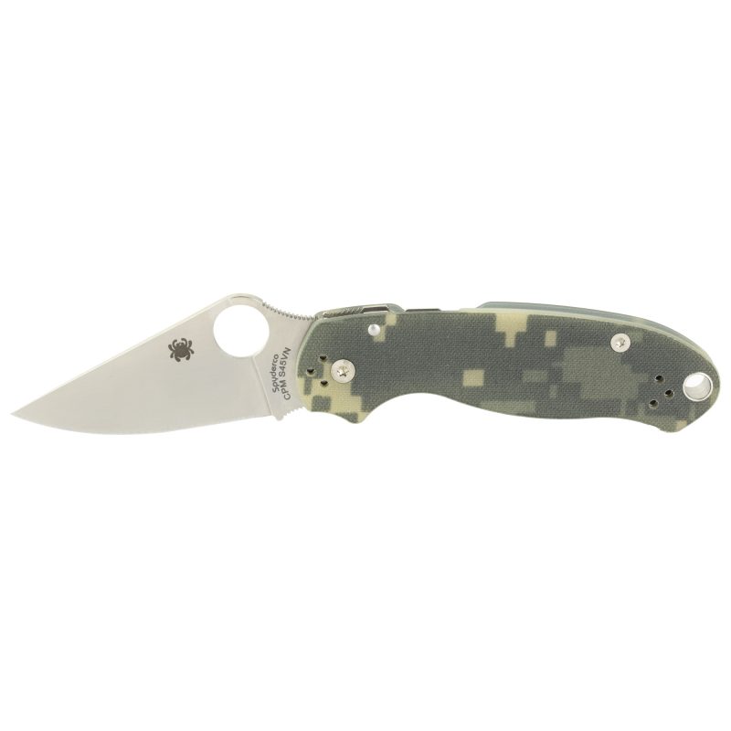 Spyderco Para3 G10 Camo Plainedge folding knife with a plain edge blade and camouflage G-10 handle, shown open on a rustic surface.