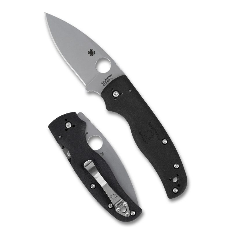 Spyderco Shaman Lightweight folding knife with black FRN handle and satin finish drop point blade, shown open on a rustic background.