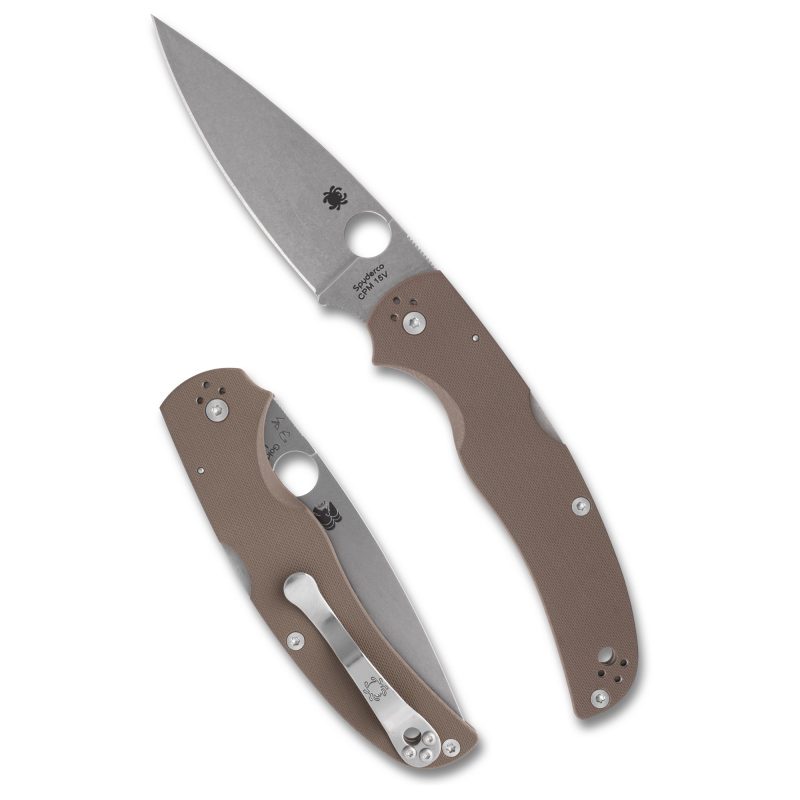Spyderco Native Chief folding knife with a silver drop point blade and brown G-10 handle, shown open on a rustic surface.
