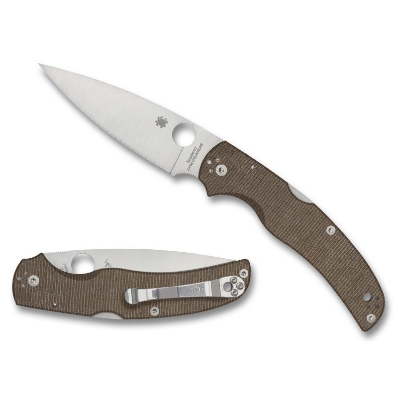 Spyderco Native Chief folding knife with a satin-finished drop point blade and brown canvas Micarta handle, shown open on a rustic surface.