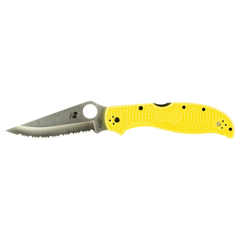 A yellow Spyderco Stretch 2 XL Lightweight Salt folding knife with a serrated H-2 steel blade, open and ready for use, against a rugged outdoor background.