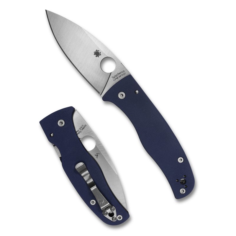 Spyderco Bodacious folding knife with a satin-finished leaf-shaped blade and a blue G-10 handle, shown open on a rustic surface.