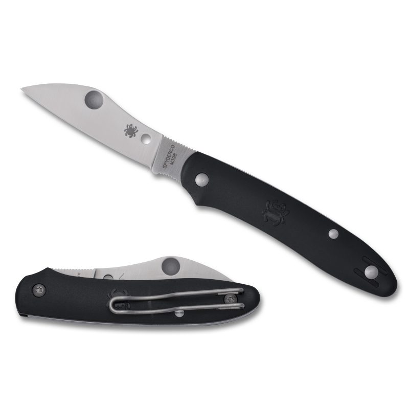 Spyderco Roadie XL Ltwt 2.74 inch black folding knife with a satin silver sheepsfoot blade and black FRN handle, shown open on a rustic surface.