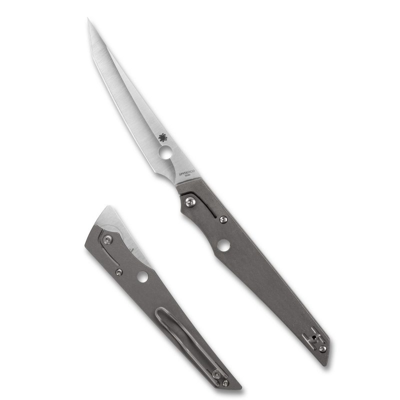 Spyderco Cobol folding knife with a gray titanium handle and a satin finish tanto blade, open on a rustic wooden surface.