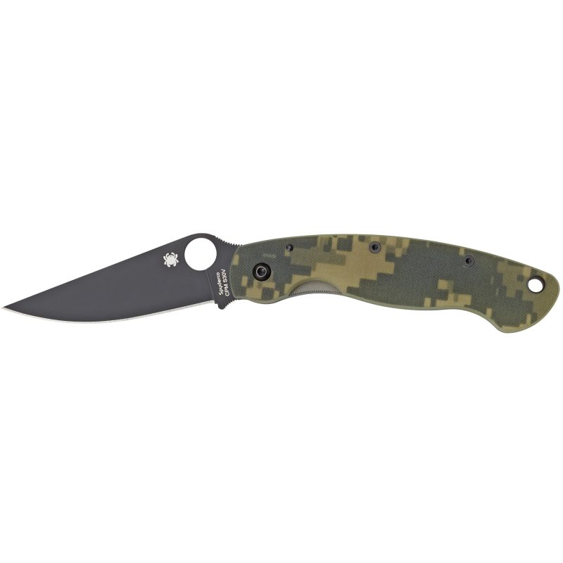 Spyderco Military Model G-10 Camo folding knife with black blade and camouflage handle, shown open on a rustic surface.