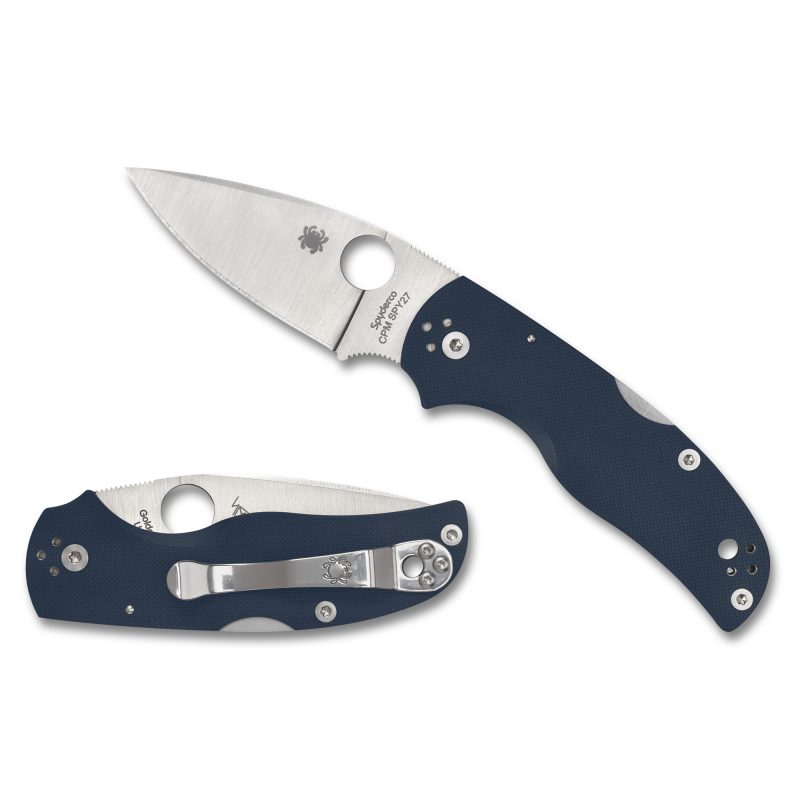 Spyderco Native 5 G-10 folding knife with a blue handle and silver drop point blade, shown open on a rustic background.