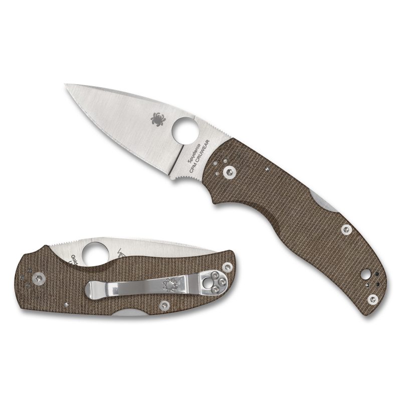 Spyderco Native 5 folding knife with a silver satin-finished drop point blade and brown canvas Micarta handle, shown open on a rustic surface.