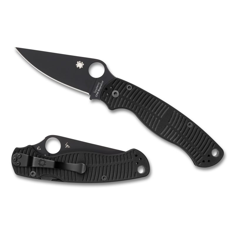Spyderco Para Military 2 Salt folding knife with black G-10 handle and black DLC coated MagnaCut plain edge blade, shown open on a rustic surface.