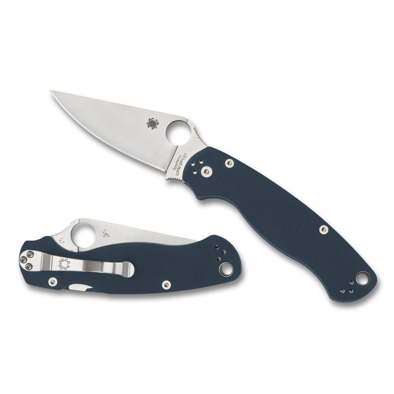 Spyderco Para Military 2 folding knife with a cobalt blue G10 handle and a satin finish plain edge blade, shown open on a rustic background.