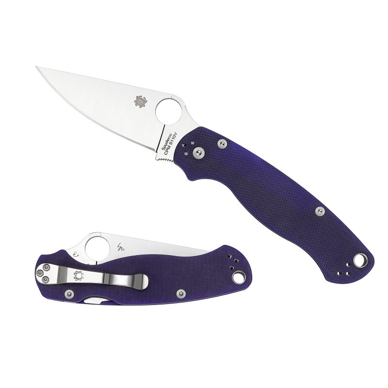 Spyderco Para Military 2 folding knife with a dark blue G10 handle and a plain edge CPM S110V blade, shown open on a rustic surface.