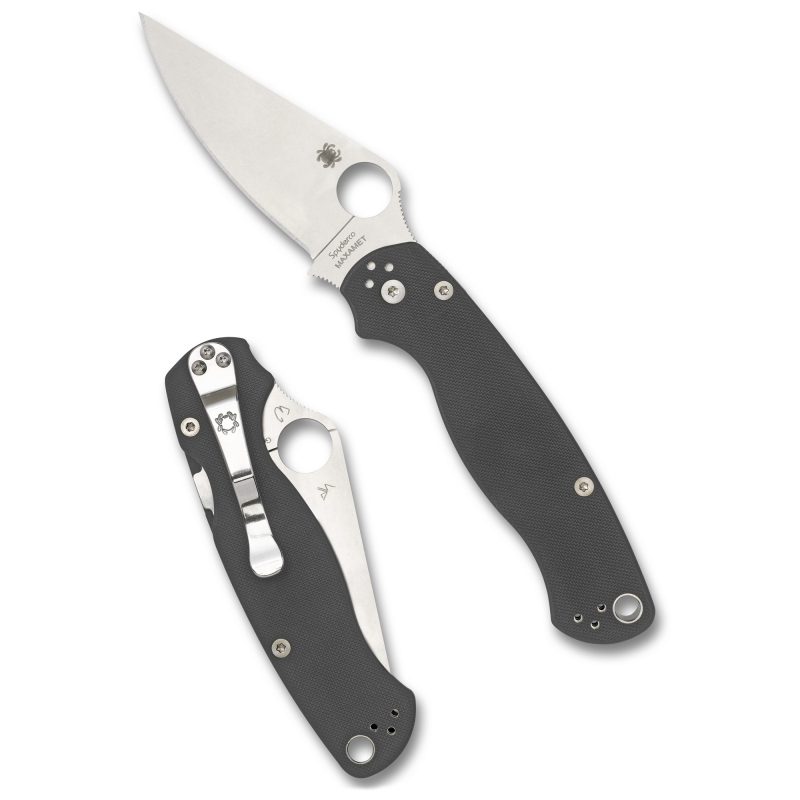 Spyderco Para Military 2 folding knife with a silver Maxamet clip point blade and gray G10 handle, shown open on a rugged outdoor surface.