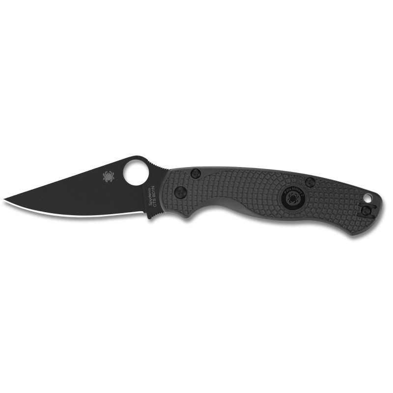 Black Spyderco Para Military 2 Lightweight folding knife with a DLC-coated clip point blade and black FRN handle, shown open on a rustic surface.