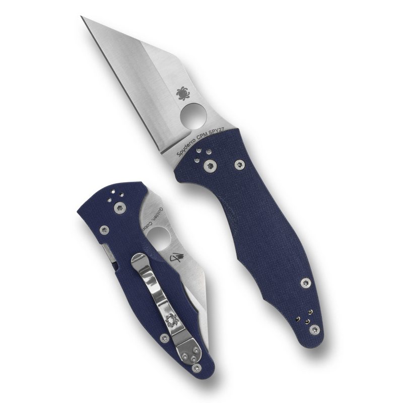 Spyderco Yojimbo 2 folding knife with a silver Wharncliffe blade and blue G-10 handle, shown open on a rustic background.