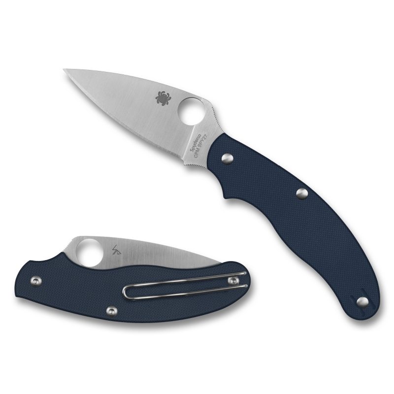 Spyderco UK Penknife G-10 with a blue handle and satin silver drop point blade, shown open on a rustic surface.
