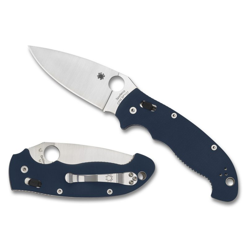 Spyderco Manix 2 XL folding knife with a silver drop point blade and blue G-10 handle, open on a rugged outdoor surface.