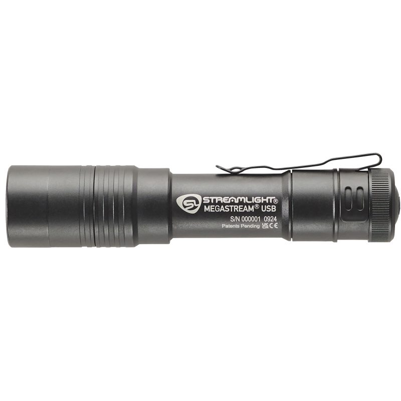 Black Streamlight Megastream USB flashlight with included SL-B34 battery pack, USB-C cord, and holster on a rugged surface.