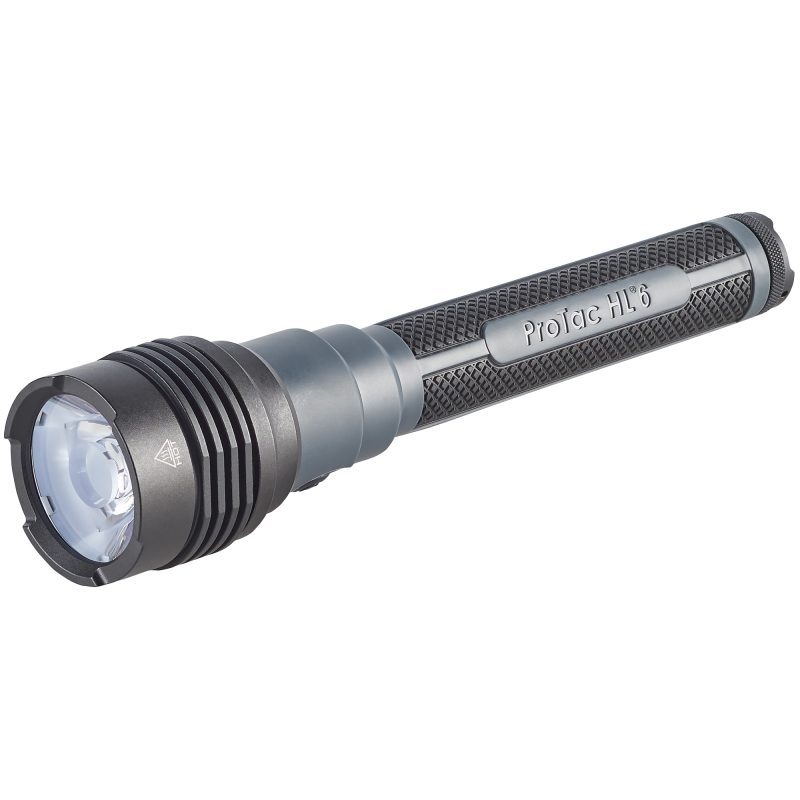 Black Streamlight ProTac HL 6 flashlight with wrist lanyard, showing the textured rubber grip and lens, on a rugged outdoor surface.